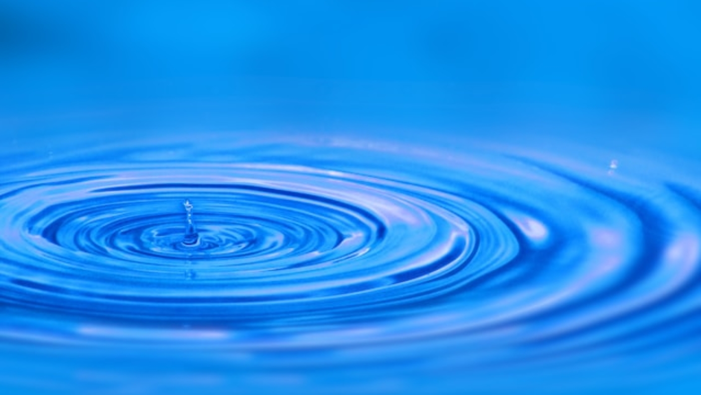 A photograph of ripples in bright blue water